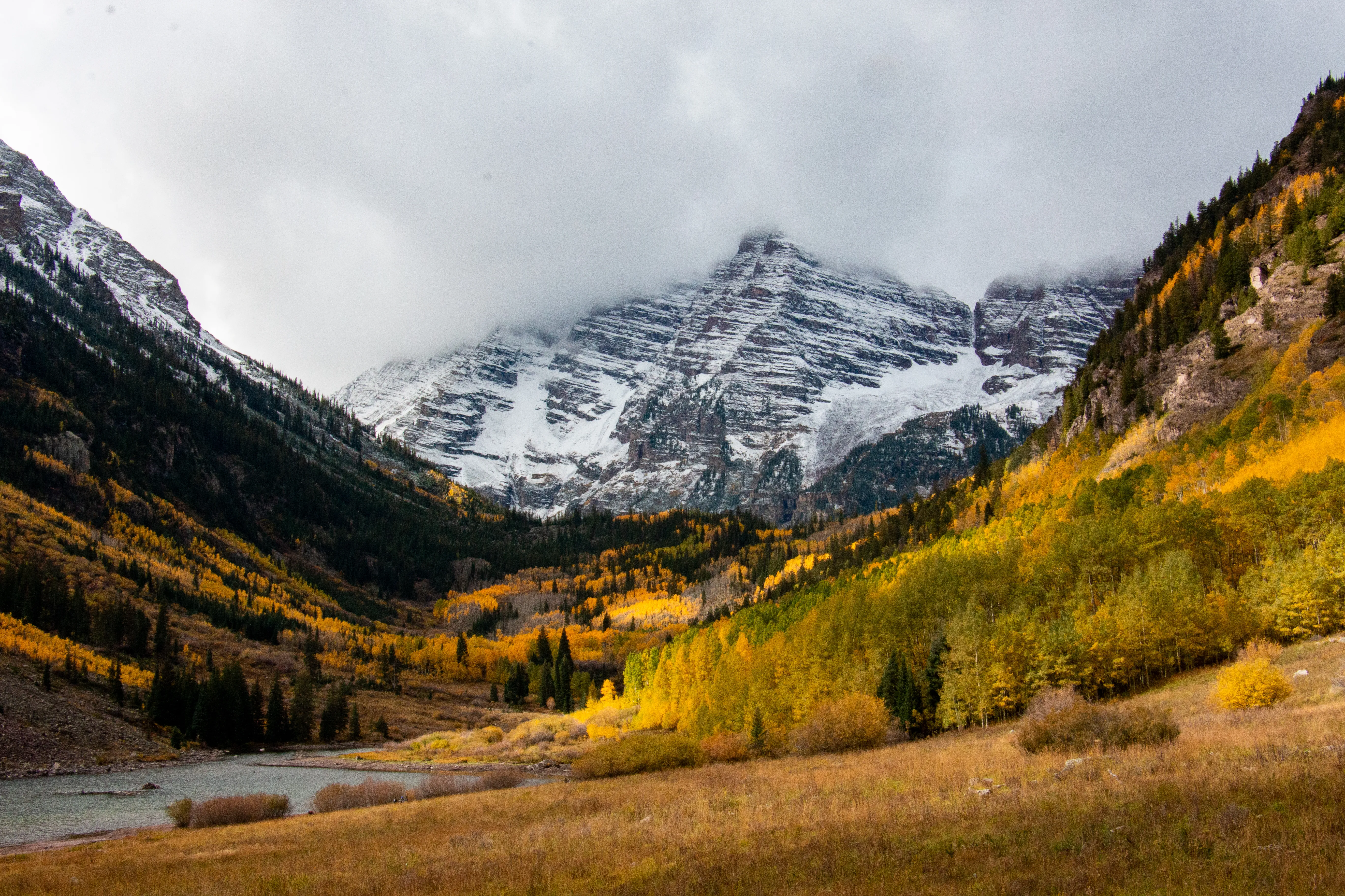Snowy Colorado peaks above golden autumn aspens