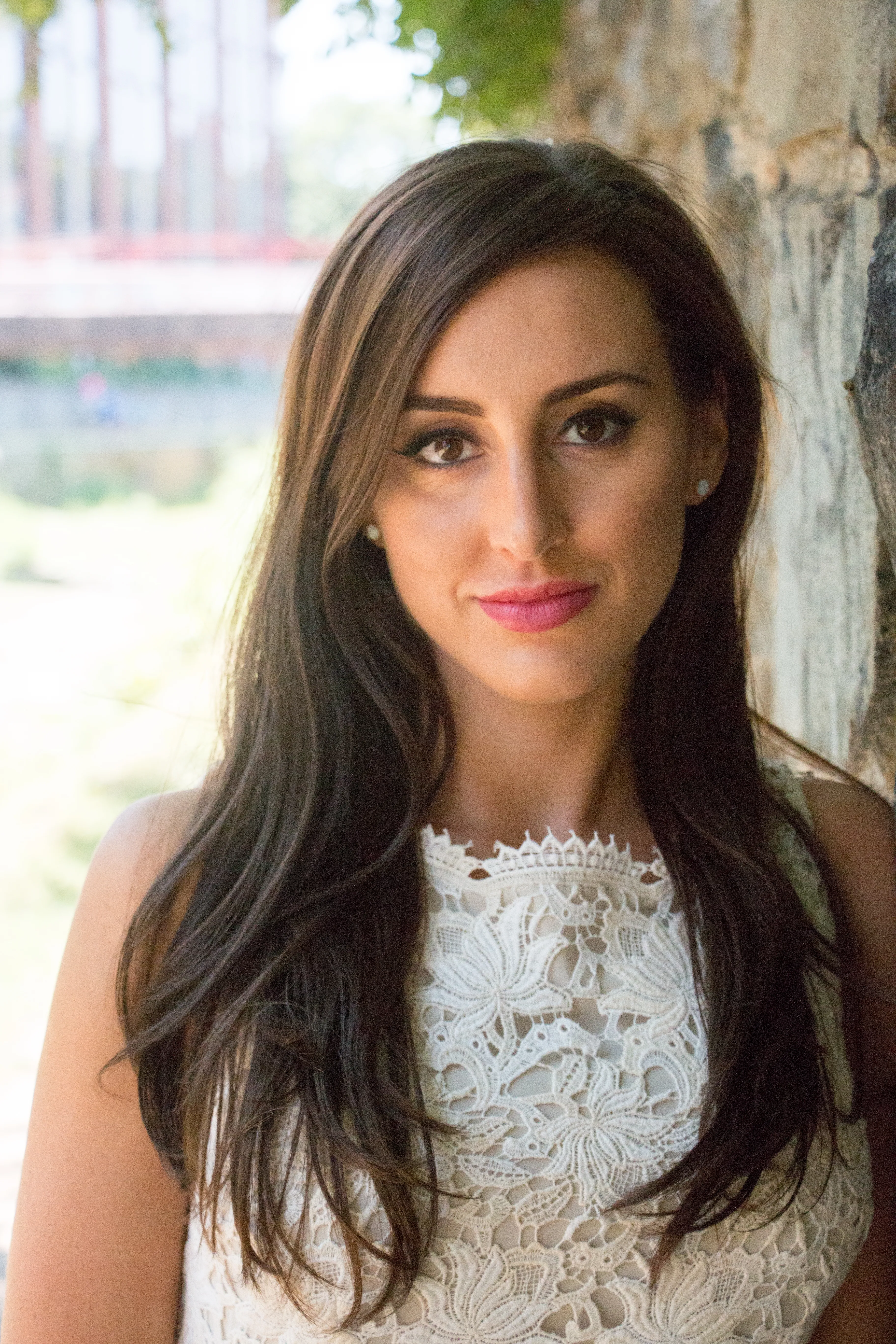 Natural-light portrait of a woman in a white lace top