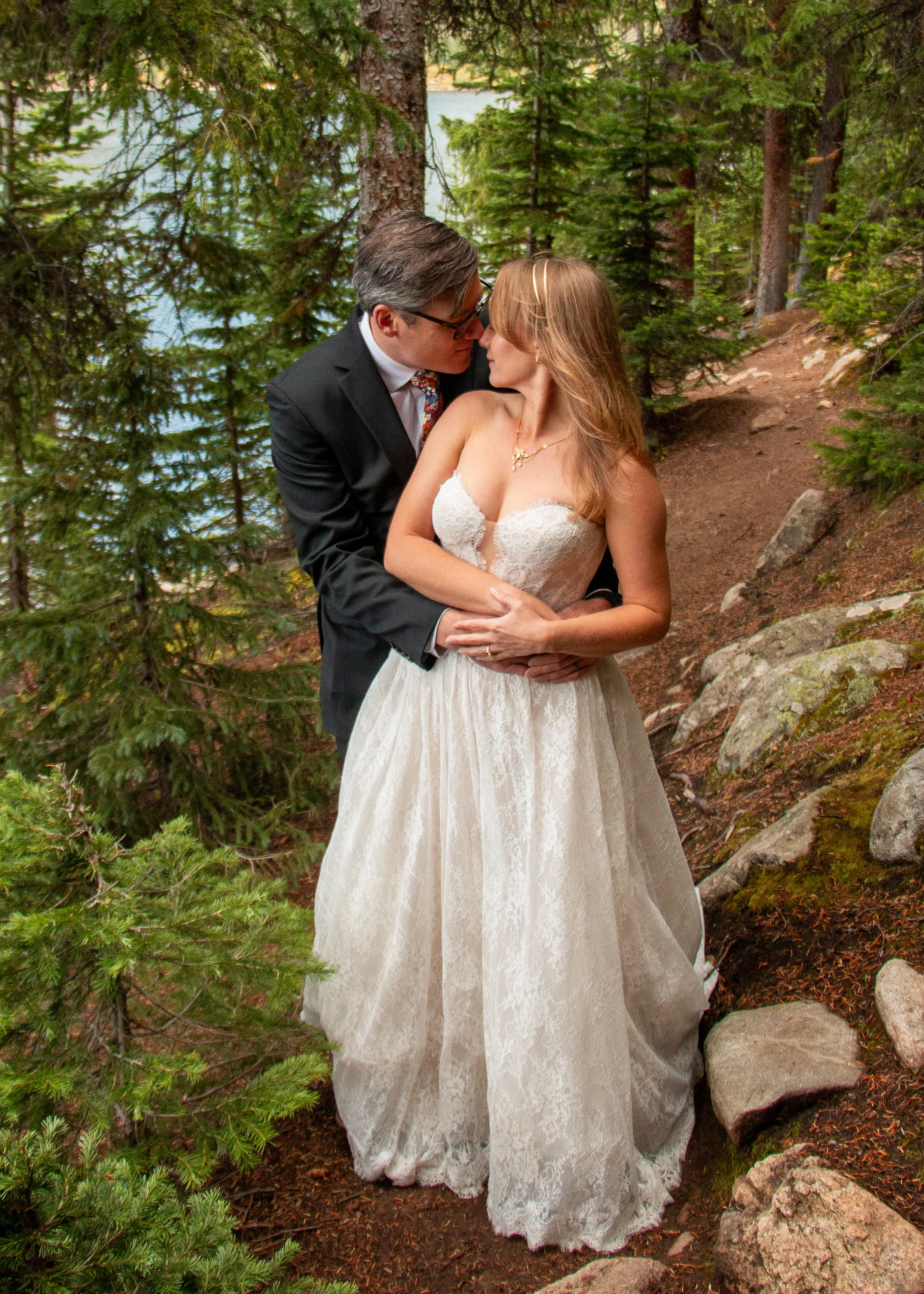 Bride and groom in an evergreen forest